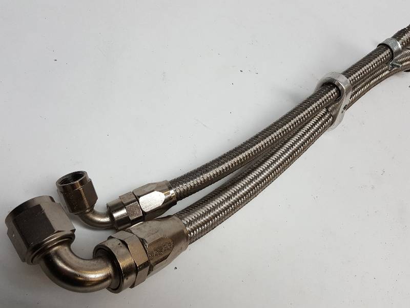 lot 7437 image: From Russel Performance are these 2 90 degree steel braided hose ends with some hose