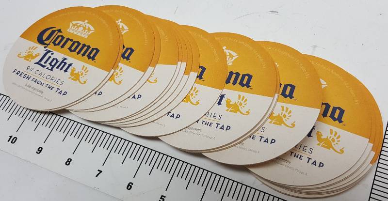 lot 7490-2 image: Package of 100 individual new Corona Light Beer 4 diameter double sided coasters for your bar