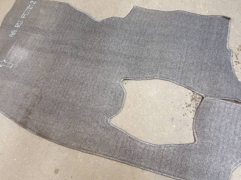 lot 7782 image: No clue what mini van or SUV this carpet insert fits.  Put your bid down and cut it to fit your application.
