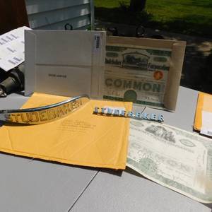 lot 8041 image: Antique Studebaker Stocks Certificates  & Emblems