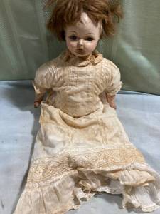 lot 7704 image: 17 inch antique doll with cracks dress hangs over doll