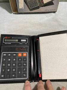 lot 7745 image: Semi- desk top calculator with portfolio and clock works