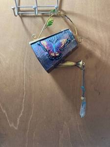 lot 7989 image: Metal watering can with butterfly wind chime