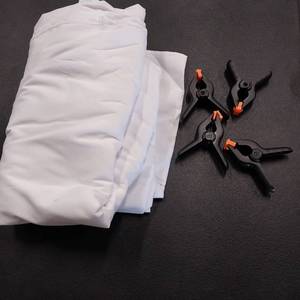 lot 7490 image: White photography backdrop with 4 clips.