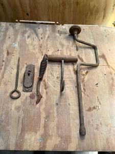 lot 1110 image: Vintage Hand Crank Drill, planer, wood burning stove lid lifter, and Hay hook,