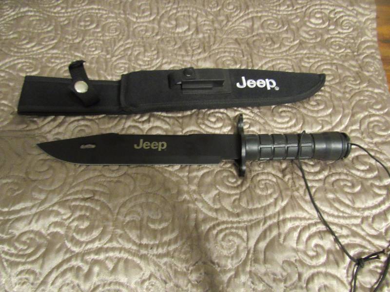 lot 7497 image: Jeep Survival knife w sheath, sharpening stone, compass, matches, fish line & hook