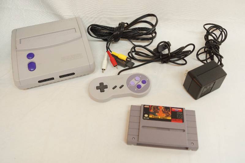 lot 4111 image: Vintage - Super NES - Nintendo Entertainment System - with cords and one game M# SNS-101 - tested and working when it was purchased a while ago. May need cleaned.