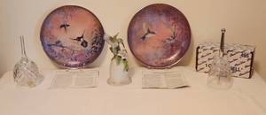 lot 1011 image: Two Bradford Exchange 8 Plates, Wing of Grace and Garden Whispers - 1 Princess House Crystal Bell - 1 Czechoslovakia Crystal 24% pbO Bell - 1 Hummingbird Bell by Seymour Mann Inc