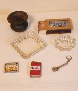 lot 1045 image: Vintage Camel and Winston Lighters - 3 Vintage Ash Trays - Vintage Box Stick Matches - Key Chain - 1 Metal Ash Tray - 2 Clear Glass Ash Trays - See Pictures