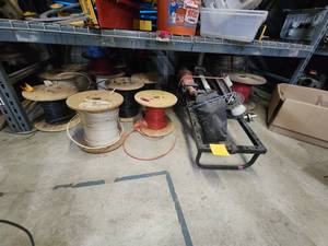 lot 47034 image: Contents Under Shelf Including Milwaukee MAXIS 3K Cable Puller, 10 AWG Wire, Rope, and More