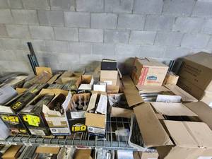 lot 47038 image: Contents of Shelf Including Iron Ridge Panel Clamps, Silicone, Module Mounts, Roof Flashing and More