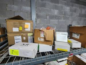 lot 47042 image: Contents of Shelf Including Micro Inverter Mounts, PV Kit 2.0 Mid Grab M8, End Caps XR, and More