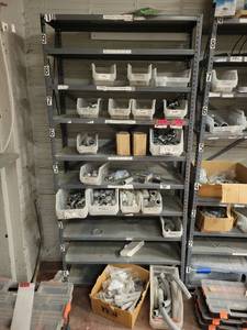 lot 15717 image: Contents of Shelf - 34in One Hole Straps, EMT Couplings, NSI Piercing Couplers, and More