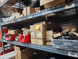 lot 47048 image: Contents of Shelf Including, 32 MM End Clamps, Mids and Ends, Mounting Systems, Micro Inverter Mounts, and More
