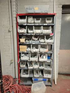lot 15725 image: Contents of Shelf - 1in Liquid Tight Connectors, Reducing Bushings, Extension Cords, and More
