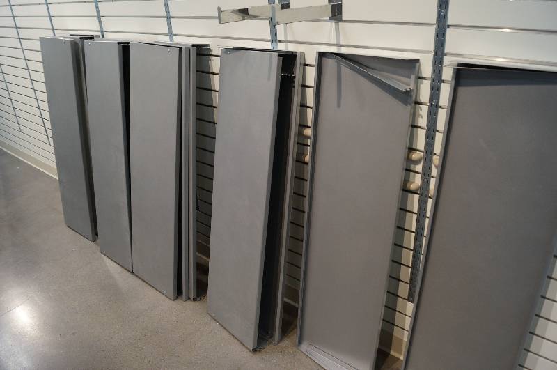 lot 7147 image: Large selection of metal shelves that fit on wall slots