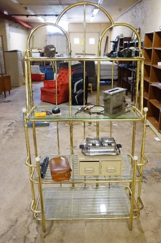 lot 11 image: Brass & glass shelf wcontentent over 6, pentax 35mm camera,antique toaster & waffle iron.