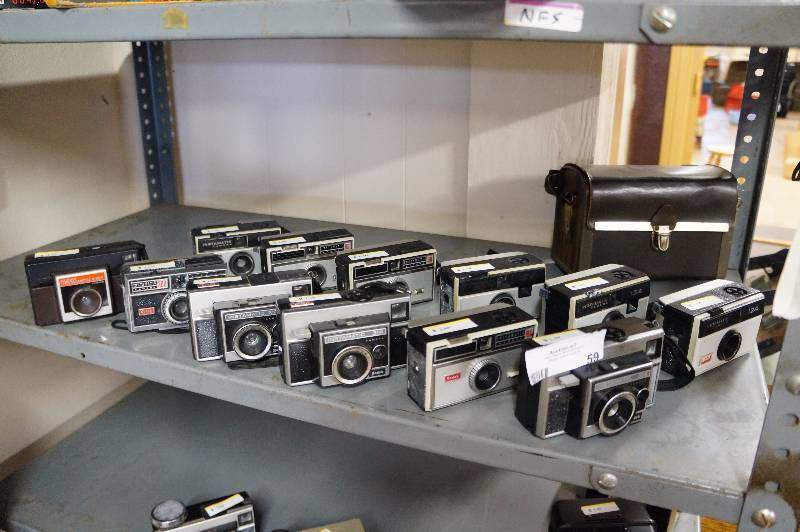lot 59 image: 13 Kodak instamatics cameras.