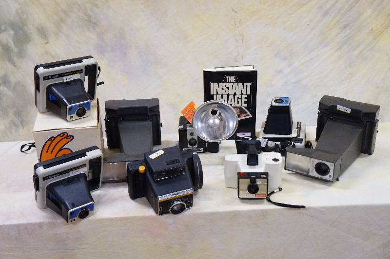 lot 89 image: Camera lot, polaroid, hawkeye, kodak, photography book, lot of 10 cameras, 2 flats.