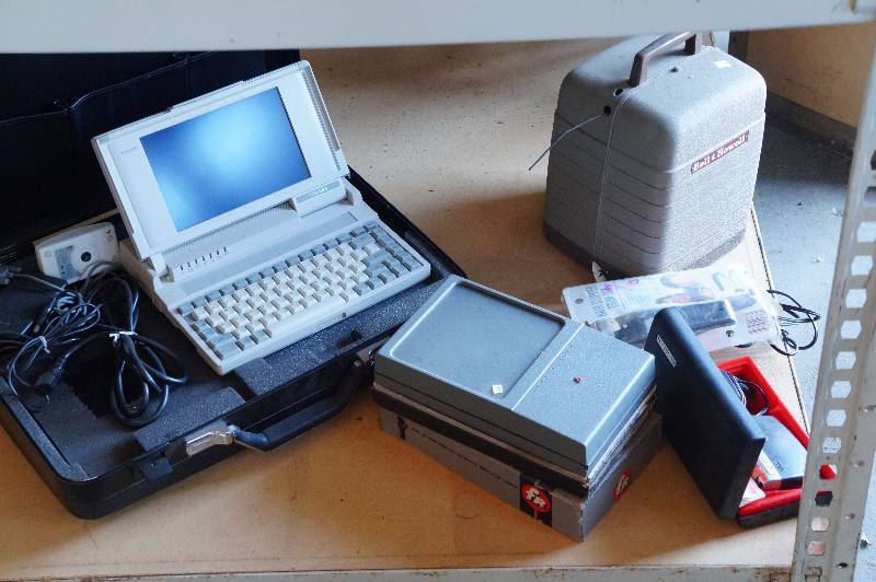 lot 118 image: Slide viewer, projector, & an old laptop computer.
