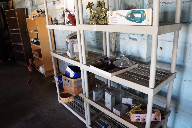lot 144 image: Contents only on 2 shelving units, clock, mens shoes 10D, black & decker brush trimmer, & misc.