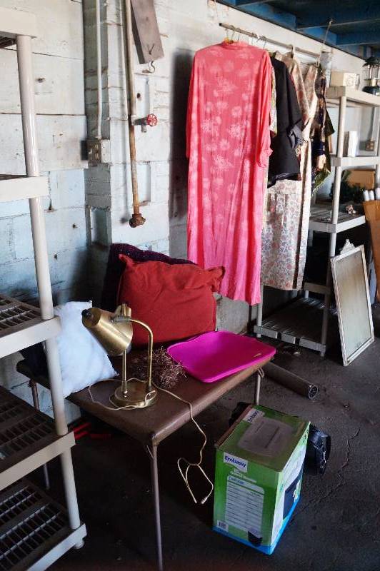 lot 146 image: Folding table wcontents & asian clothing, pillows, hats, shredder.