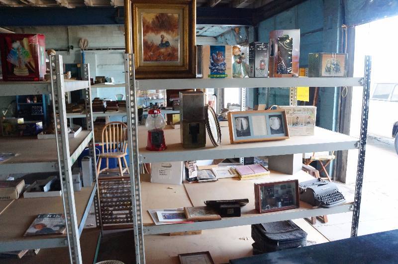 lot 167 image: Entire contents of shelving unit, gumball machine, typewriter, art, frames, misc(shelf not included).