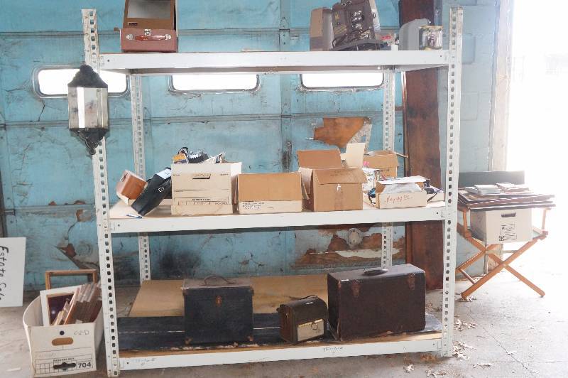 lot 171 image: Entire contents of shelving unit, cameras metres, cases, bulbs,chair, frames, misc(shelf not included).