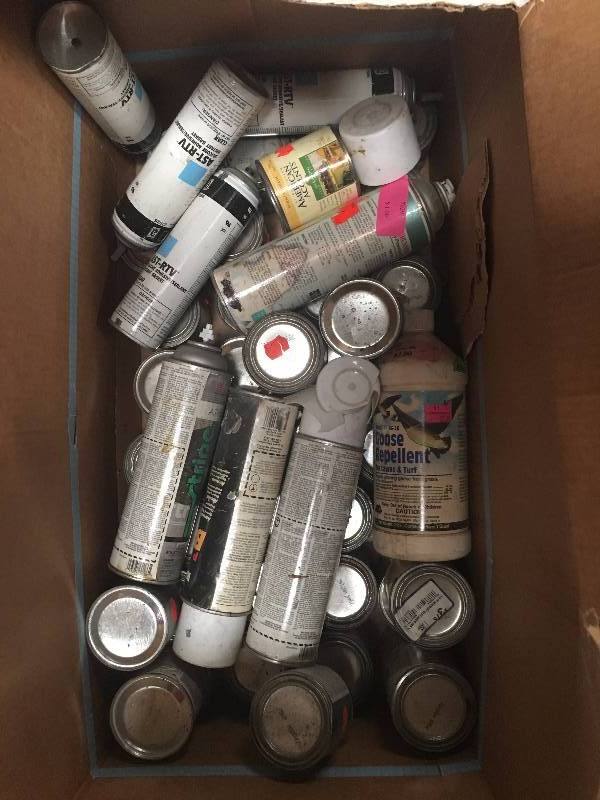 lot 1100 image: Box of assorted trim paint, primer and spray adhesives