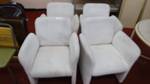 Set of 4 upholstered arm chairs on casters.
