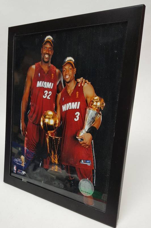 lot 6995 image: The Miami Heats Shaquille ONeal #32 and MVP Dwyane Wade #3 after championship