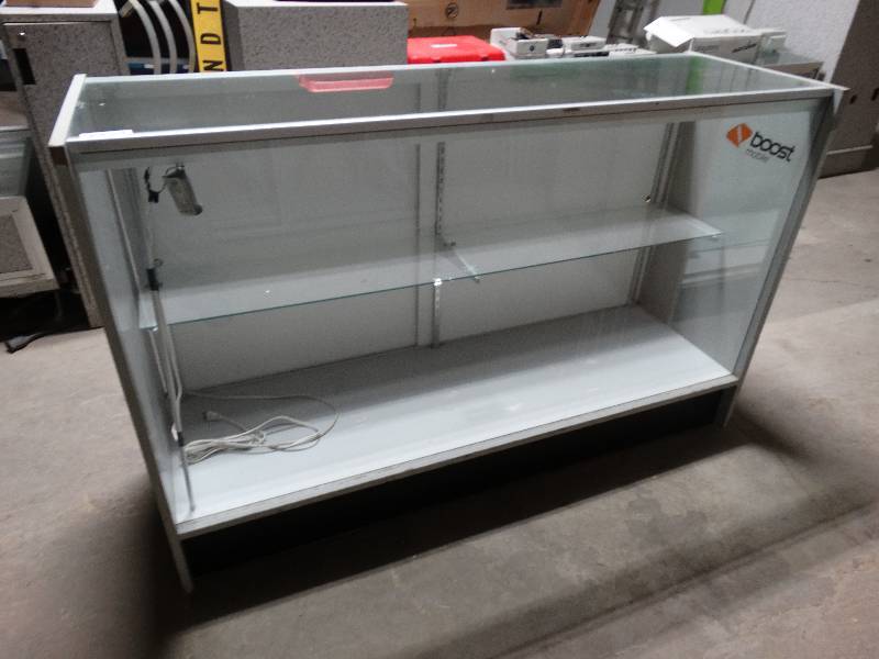 lot 436 image: Full front glass showcase with sliding back doors.