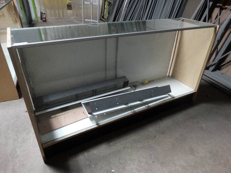 lot 438 image: Full front glass showcase with sliding back doors.