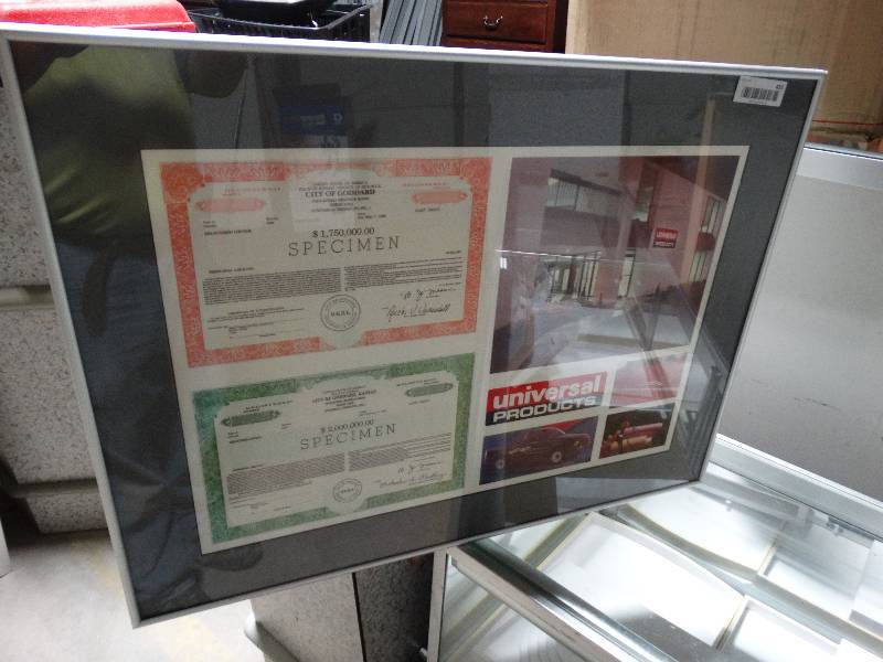 lot 455 image: Framed copy of Universal Products 2 city of Goddard revenue bond certificates