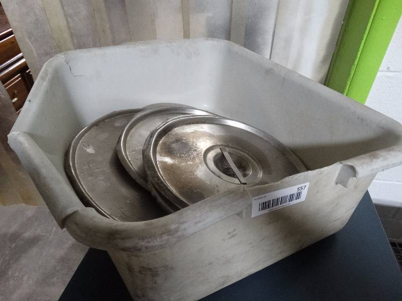 lot 557 image: Bus tub with various stock pot lids.