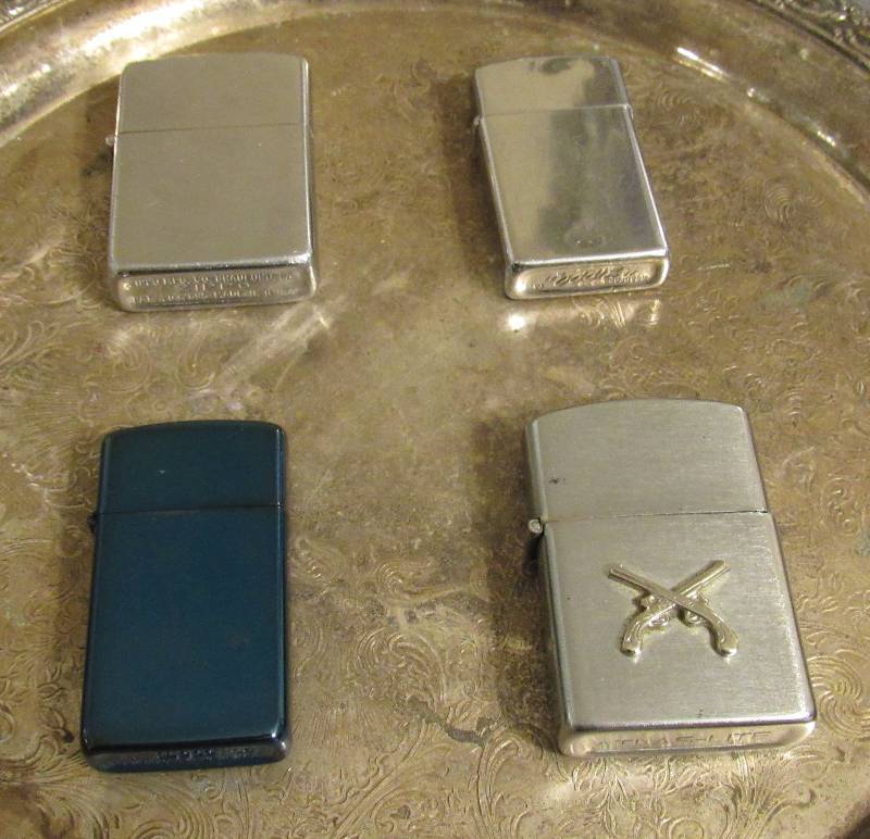 lot 7814 image: Lot of 4 Zippo Lighters - 2 silver, 1 blue, 2 w guns