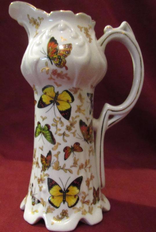lot 7917 image: Butterfly Ceramic Pitcher - features beautiful butterfly art