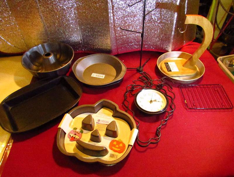 lot 2078 image: Lot of Baking Ware and Kitchen Items - New Jack-O-Lantern Cake Pan, Bundt Cake Pan, Grape Shaped Metal Clock, NEW Banana Tree, Metal Coffee Cup Stand and More