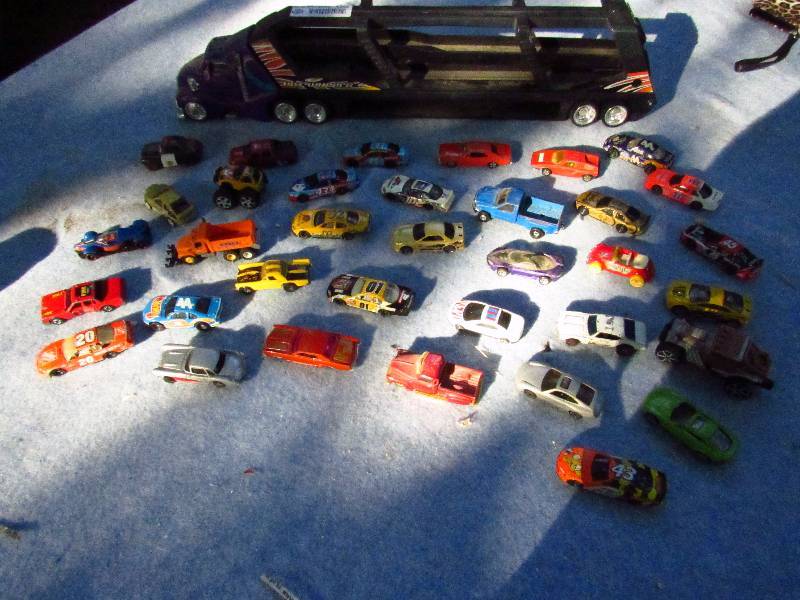 lot 1296 image: Lot of MatchBox Cars - Hot Wheels with MatchBox Semi & Trailer for storage - Hours of fun See photo for items included