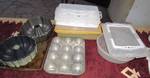 Lot of baking pans and carrying containers - bundt cake pans, cupcake pans, cookie sheet and more! See photo