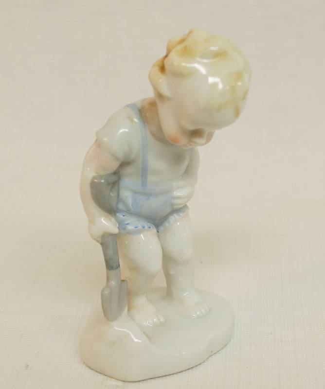 lot 2445 image: Porcelain Figurine - Little Boy with shovel looking down - Marked on bottom May 1932 Very sweet
