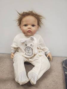 lot 5038 image: weighted baby doll.  distressed from shipping
