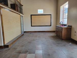 lot 29566 image: Entire Contents of Room - Light Wood Slat Wall, Dark Wood Cabinetry, Receptionist Desk, and More