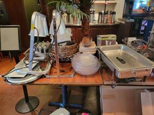 lot 18731 image: Contents on Table - Fusion Commercial Food Warmer, AM Wood Serving Boards W Handles, Monogram Butane Fuel Cartridge, and More