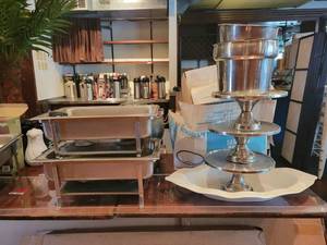 lot 18732 image: Contents of Table - Chaffing Dishes, Stainless Steel Cake Stands, Sterno Wire Racks, and More