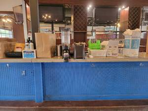 lot 18766 image: Contents on Bar Top - New Leaf Gravity Bin, Steramine Multi-Purpose Sanitizer Tablets, Bar Countertop Mats, and More