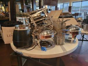 lot 18739 image: Contents of Table - Chaffing Dishes, Large Soup Warmer, Fryer Baskets, and More
