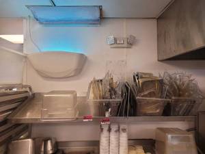 lot 18653 image: 64in Slanted Stainless Steel Wall-Mount Shelf