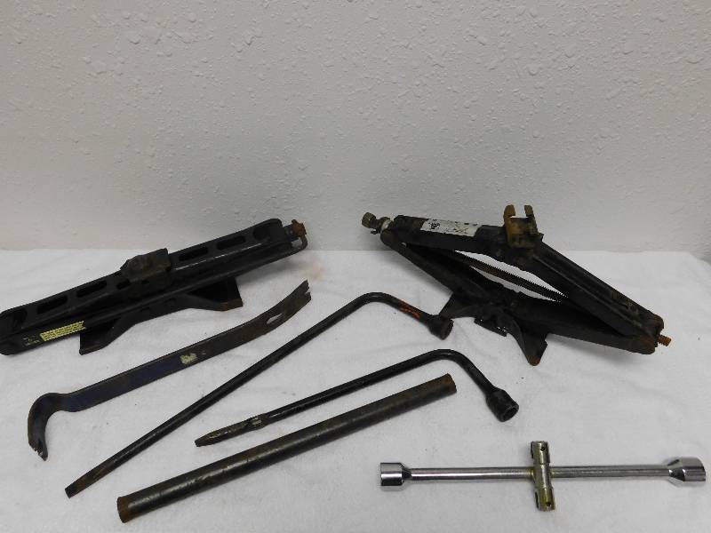 lot 7136 image: Tire Irons, Car Lifts and Metallic Ram Rods.