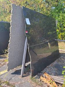 lot 7010 image: Polished Black Pearl Remnant Slab and a Ubatuba Polished Granite Slab